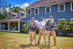lifestyle photography of 3 mosquito squad employees in front of a house for Mosquito Squad