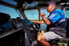 lifestyle photography of man driving a boat for Raymarine FLIR in Hudson, NH