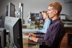 lifestyle photography of a lineup of men working on their computers for Datum