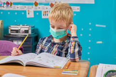 lifestyle photography of child doing work at school with face mask  for EFGB in Boston, MA