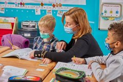 lifestyle photography of teacher helping child with his work  for EFGB in Boston, MA