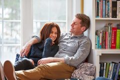 Lifestyle photography of man and woman sitting together on a window bench for Jassby in Waltham, MA