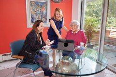 lifestyle photography of three women sitting at a table