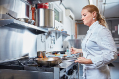 Lifestyle photography of Chef Sarah Wade cooking on the stove