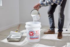 lifestyle photography of man pouring paint into a bucket for United Solutions in Leominster, MA