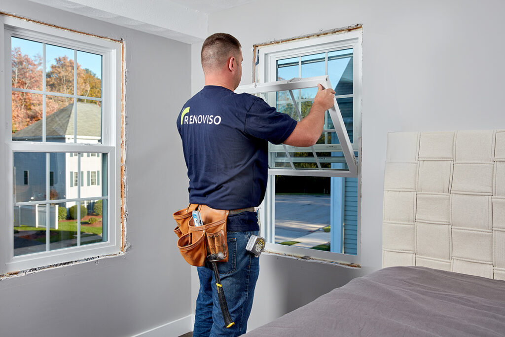 Lifestyle product photography of an employee installing a window for RenoViso of Boston, MA