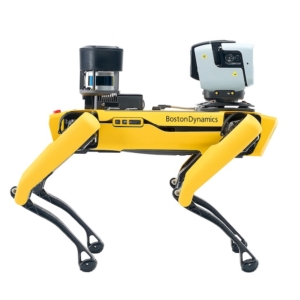 A side-profile product photograph of a yellow Boston Dynamics Spot robot against a white background. The shot highlights the robot's quadruped design and integrated industrial payloads, including a Leica BLKARC laser scanner and a Velodyne LiDAR sensor, showcasing clean lines and technical precision.