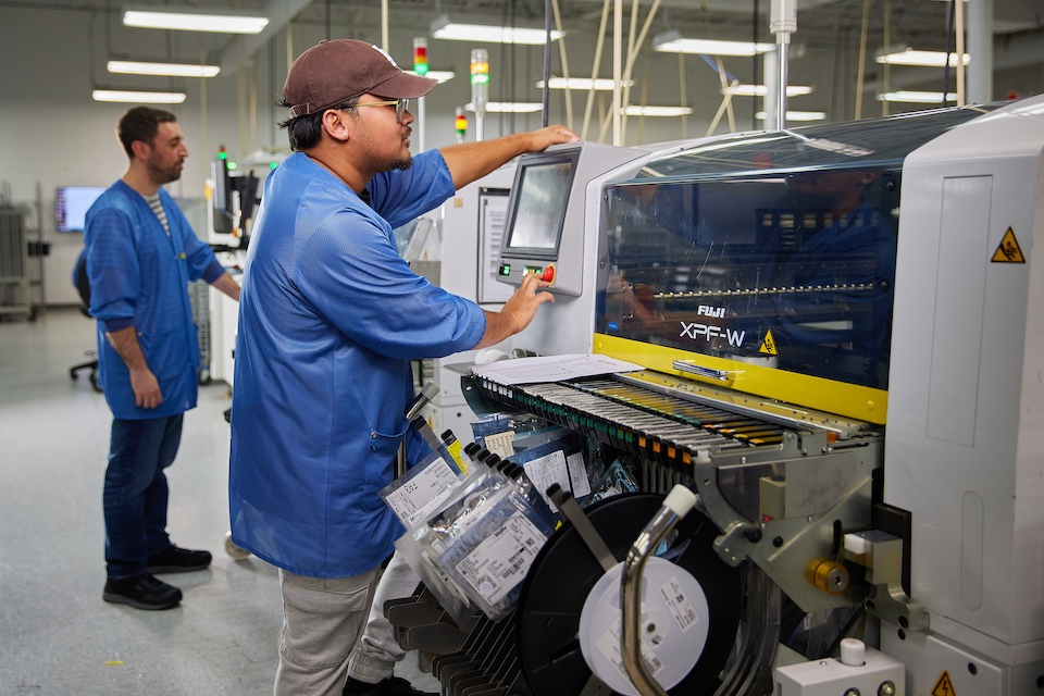 Onsite lifestyle photography male employee operating machine for Accutronics of Chelmsford, MA.