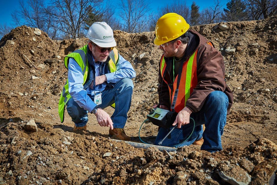 Lifestyle photography of two male construction workers at field test for Bascom Turner Instruments in Norwood, MA