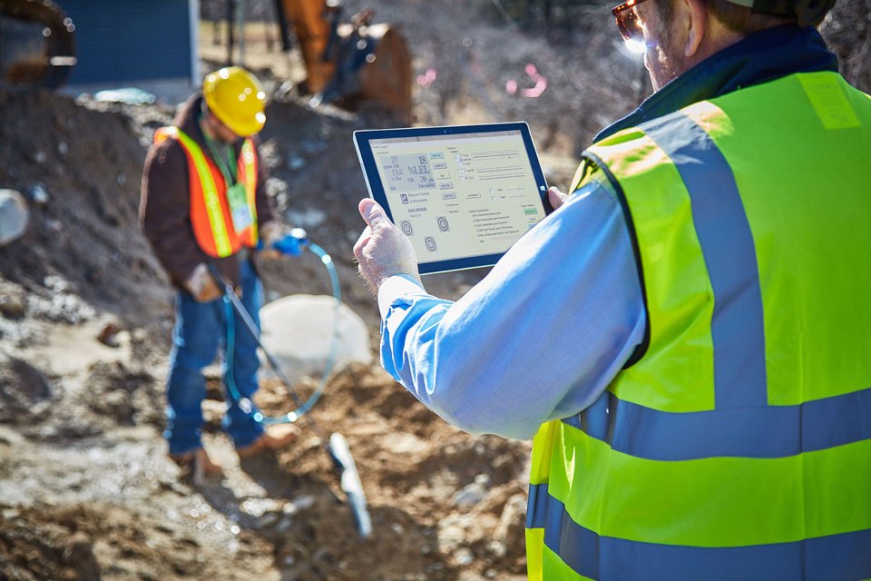 Lifestyle photography of construction worker in safety vest holding a tablet for Bascom Turner Instruments of Norwood, MA.