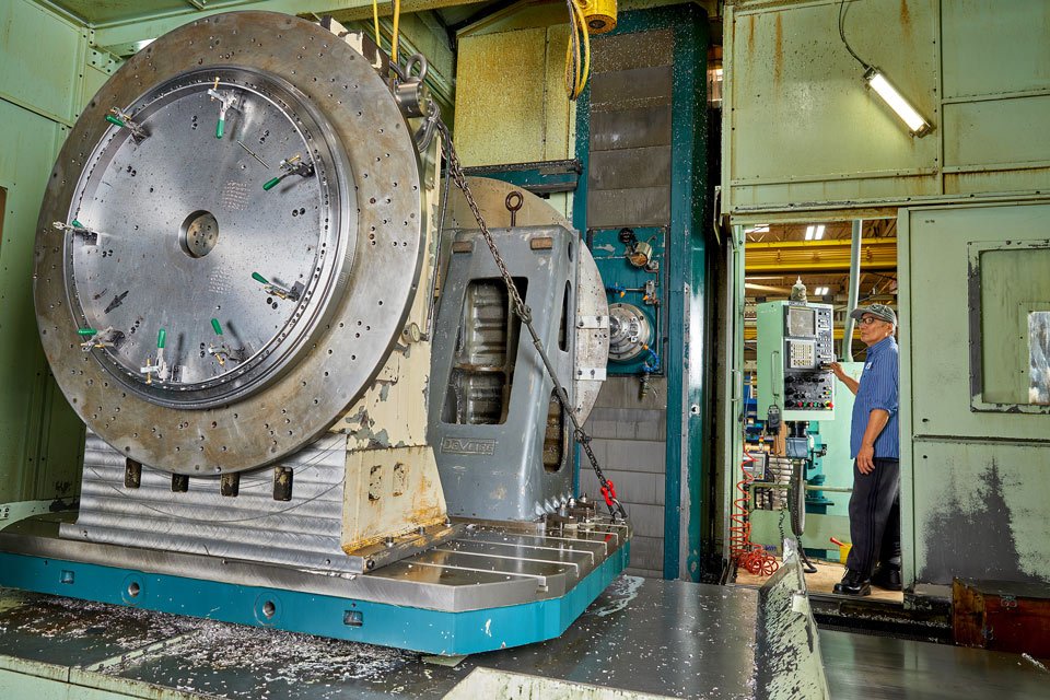 lifestyle photography of male employee in a doorway operating a large machine for B and F Machines of New Britain, CT.