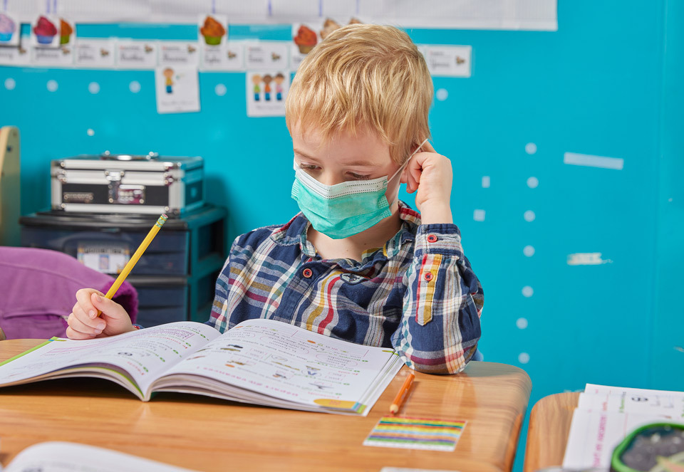 lifestyle photography of child doing work at school with face mask  for EFGB of Boston, MA.