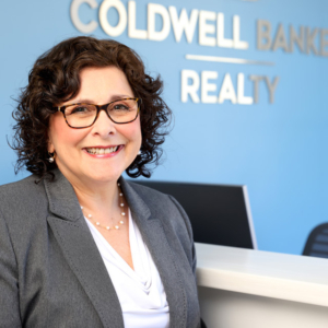 woman headshot photography with office background for Coldwell Banker Realty in Lynnfield, MA woman headshot photography with office background for Coldwell Banker Realty in Lynnfield, MA