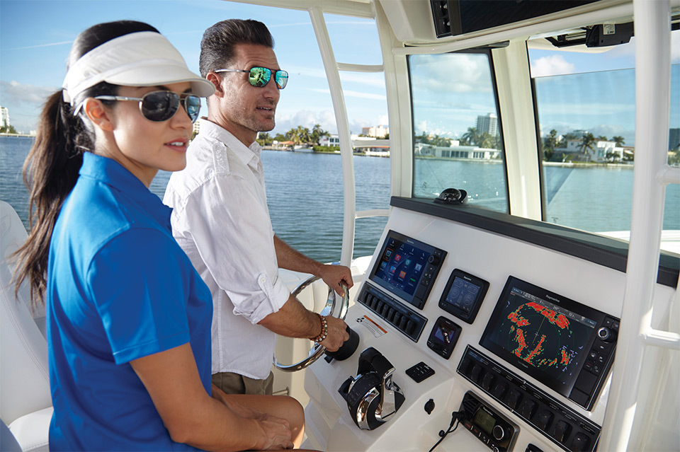 Lifestyle photography of a male steering a boat with female passenger using Raymarine FLIR Quantum for Teledyne-FLIR of Hudson, NH