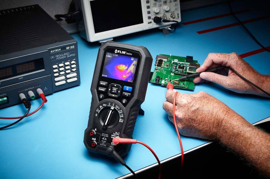 lifestyle photography of FLIR's DM284 in use for FLIR lifestyle photography of FLIRs DM284 thermal camera in use with a circuit board for Teledyne-FLIR of Hudson, NH