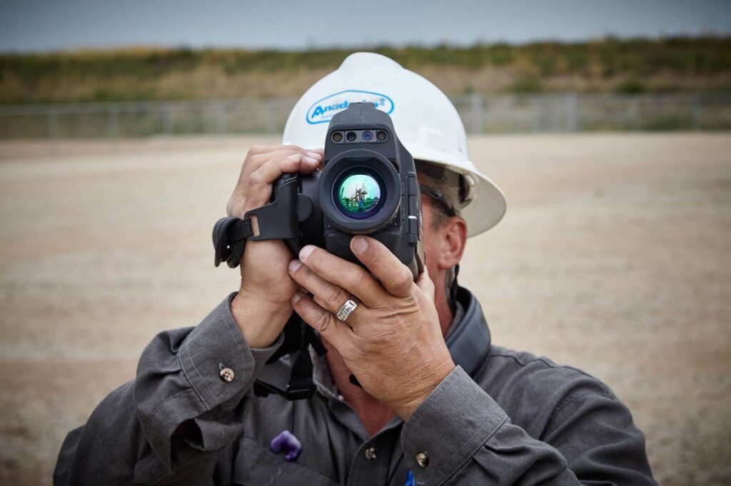 Lifestyle photography of male worker looking through thermal camera FLIR GFX app Hudson, NH.