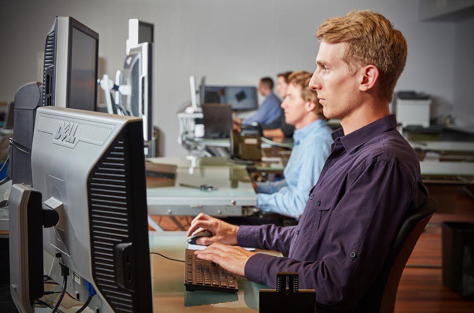 lifestyle photography of a lineup of men working on their computers for Datum of Watertown, MA.