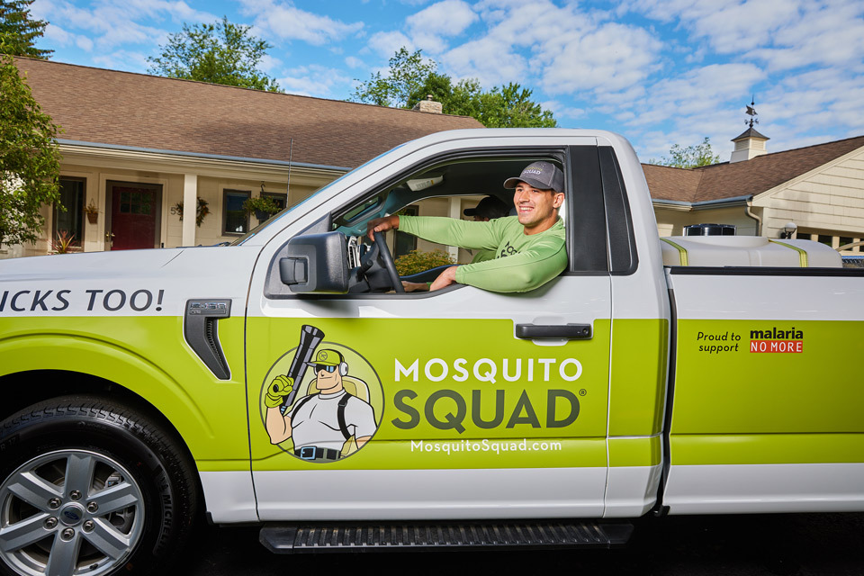 lifestyle photography of male worker sitting inside of a truck for Mosquito Squad of Chelmsford, MA.