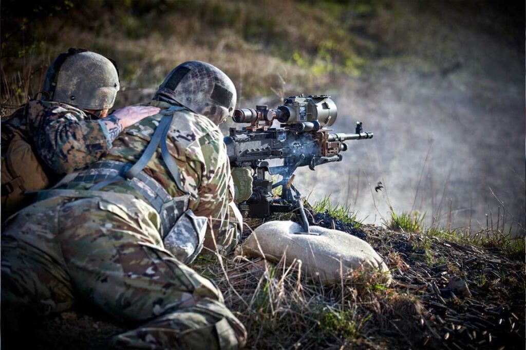 lifestyle photography of military people firing a gun lifestyle photography of US soldiers on the ground testing thermal scopes for teledyne-flir of Hudson, NH.