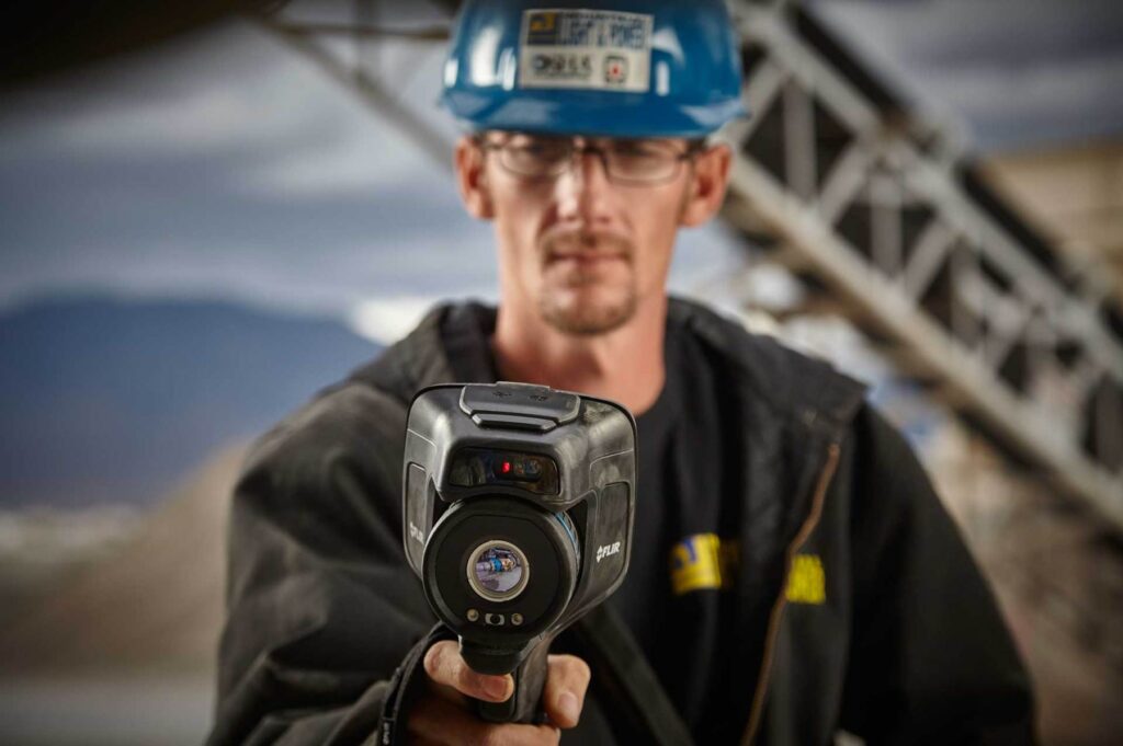 Lifestyle photography of male worker using FLIR E95 thermal camera for Teledyne-FLIR of Hudson, NH.