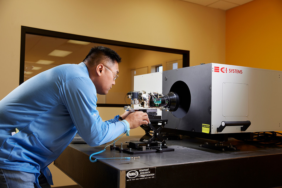 lifestyle photography of technician calibrating a camera for AIRS of Hudson, NH.